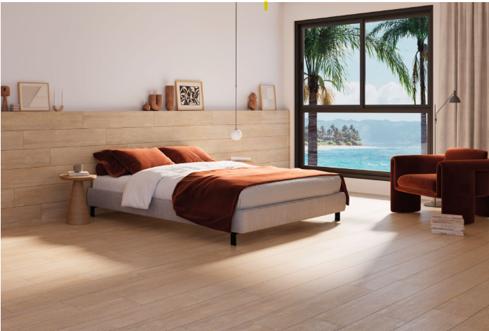 Quarto moderno com piso e painel de cabeceira de cerâmica imitando madeira. Uma cabeceira e uma poltrona com revestimento cerâmico são destaques na decoração.